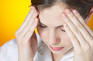 Girl holding her head because of headache